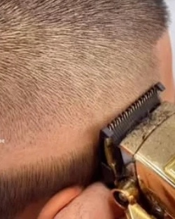 Close-up of a low taper being cleaned up with gold clippers